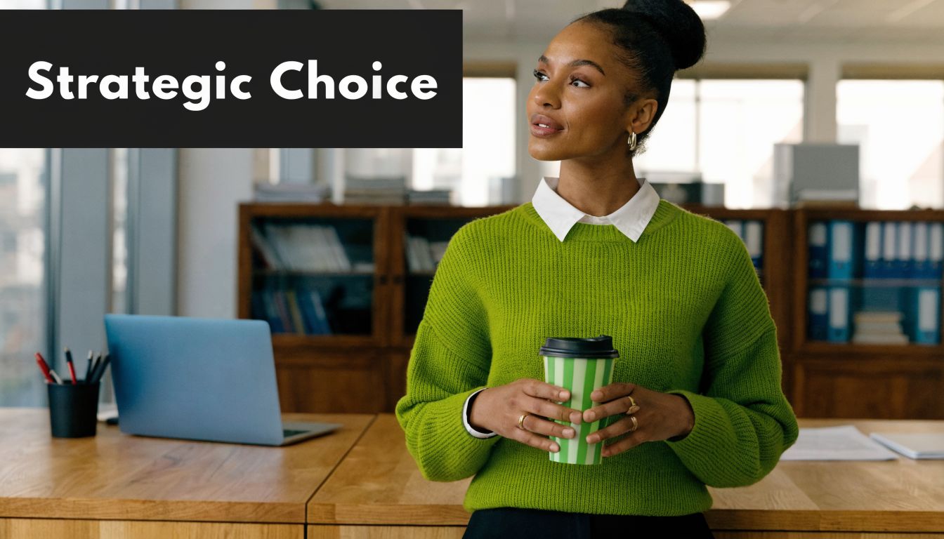 A professional woman in a green sweater holding a coffee cup while looking thoughtfully in an office.